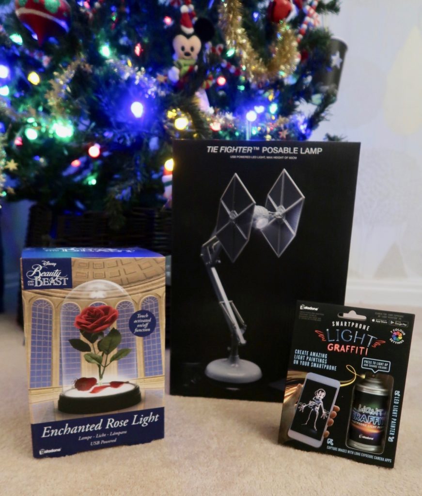 a picture showing three gifts, a star wars lamp, a enchanted rose lamp and a fun graffiti light to use with a smartphone